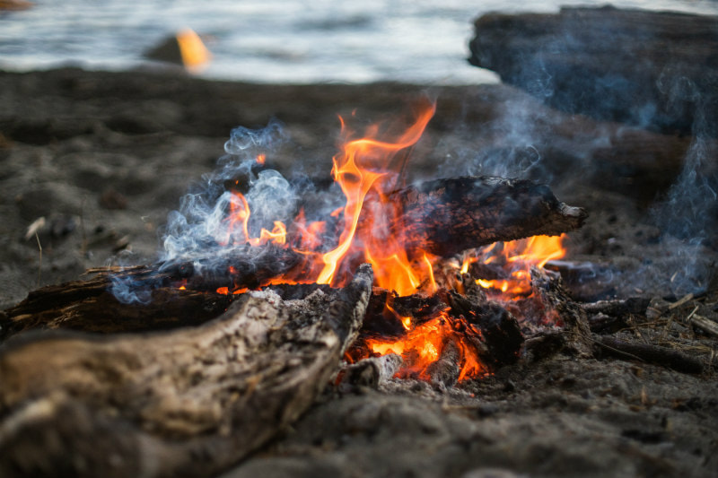 Camp fire on a beach.