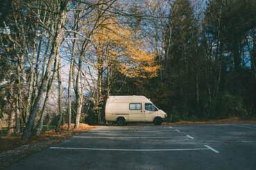 Solitary camper van in scenic carpark, illustrating the page theme, ‘enjoying solitude’.
