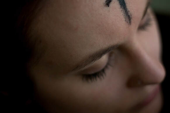 Close-p of girl's forehead, marked with an ash cross.