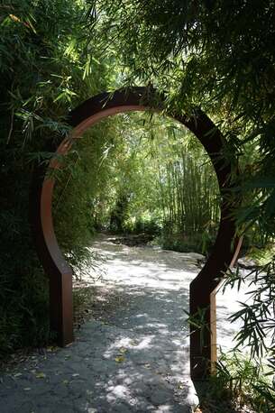 Sculptured archway to a leafy garden, illustrating Adam and Eve’s experience of meeting God in the Garden of Eden.