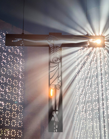 Cross with modern depiction of Jesus, and light shining through it.
