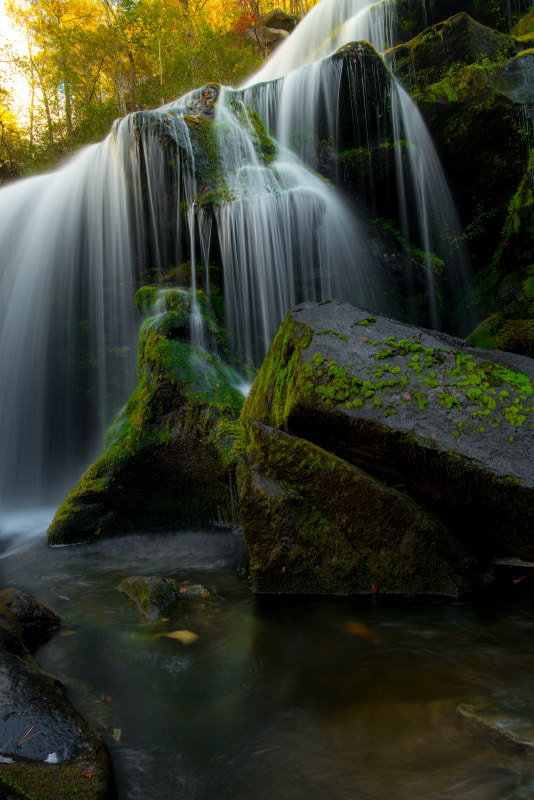 Waterfall gushing over rocks.