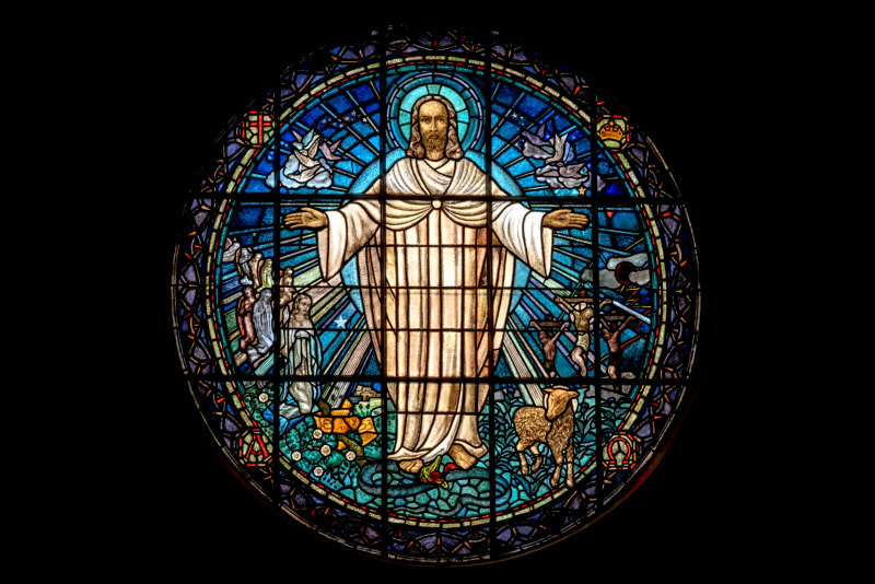Round stained-glass window showing the risen, exalted Christ.  t.