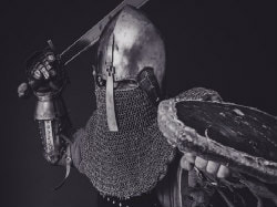 Armoured knight with raised sword, picture link to 'Slaying Giants' page.