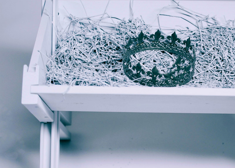 Close-up of a crown in a manger.