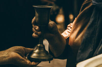 Communion cup shared between two people, Illustrating the power of the blood of the Lamb.