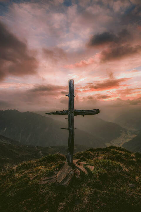 Rough wooden cross on a mountain top