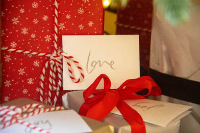 Wrapped gifts, one labelled, ‘love’, illustrating the need to unwrap the grace-filled gifts of God.
