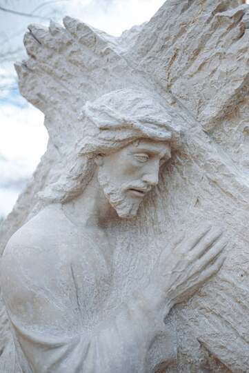 Carving of Jesus carrying the cross, illustration of Isaiah chapter 53.