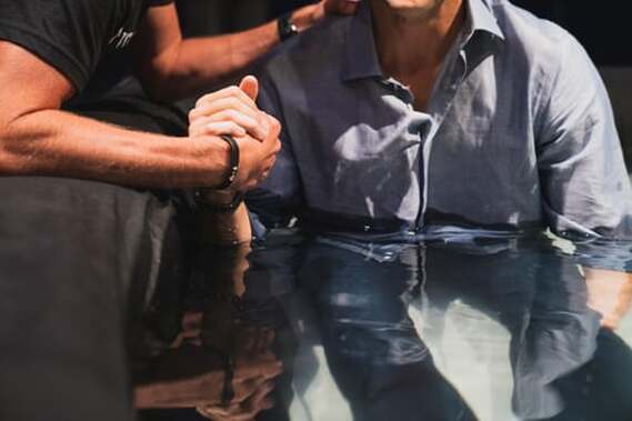 Man being baptised by full immersion.