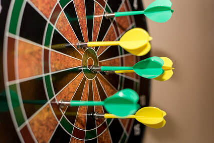 Darts on a dartboard, illustrating page title, ‘Missing the mark: Overcoming Guilt and Shame’.