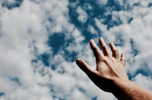 Close-up of a hand reaching to the sky, illustrating the page title, ‘Spirit-Led Encounters: The Rhythm of Devotion’.