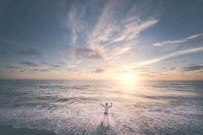 Lone figure, paddling in the sea, at sun-rise, illustrating the page title, ‘Spirit-led Withdrawal: the Rhythm of Solitude’.