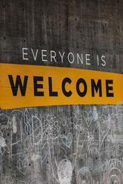 Wooden board displaying the message, ‘Everyone is Welcome’.