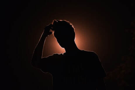 Silhouette of person in quizzical posture, illustrating the question, ‘Who am I really?’