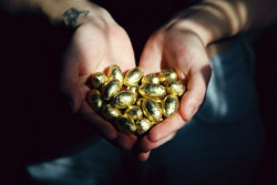 Hands outstretched filled with gold nuggets.Picture